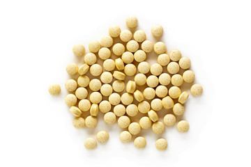 Folic Acid Vitamin Supplements. A pile of folic acid vitamin supplement tablets isolated on a white background from above.