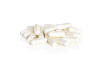 Magnesium Vitamin Supplements. A pile of magnesium supplement capsules isolated on a white background.