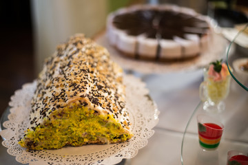 Table with sweets, birthday cake, cocktails, pastries. On the birthday cake name (Ukrainian)