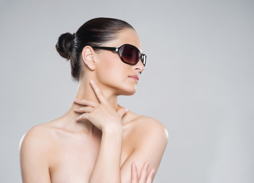 Beauty portrait of young, attractive, fresh, healthy and natural woman in sunglasses