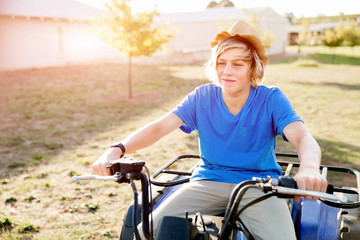 Obraz premium Boy riding farm truck in vineyard