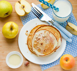 Morning meal: pancakes with fresh apples, sweet syrup and hazeln