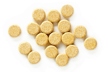 Vitamin C Tablet Supplements. A pile of vitamin C supplement tablets isolated on a white background from above.