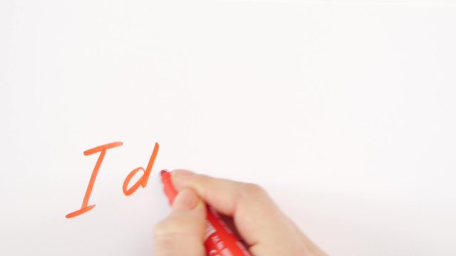 Hand of woman writing goal idea on paper