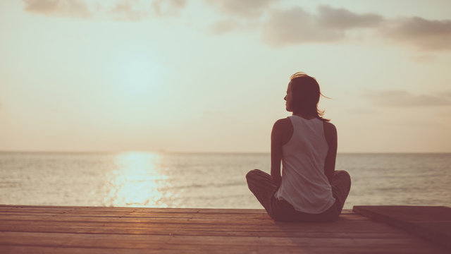 Young woman is doing yoga