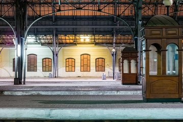 Passenger platform at night on the railway station. Train station at night.
