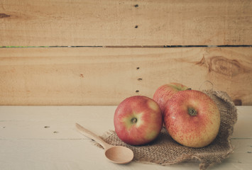 Still life with apples on wooden background