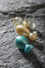 Gel capsules on a stone background