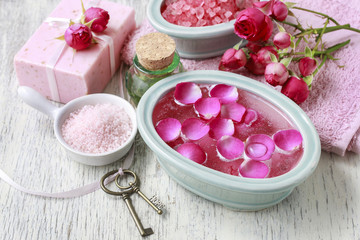 Fototapeta na wymiar Nail spa enriching treatment with essential oils and rose petals