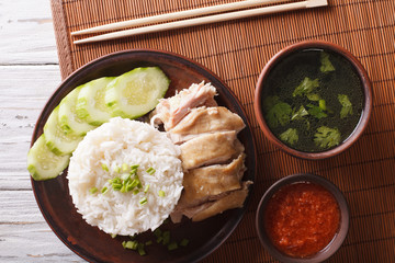 Hainanese chicken rice, chilli sauce and bouillon close-up. horizontal top view 
