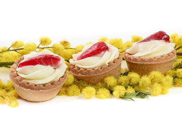 three strawberry pastry and mimosa on white background