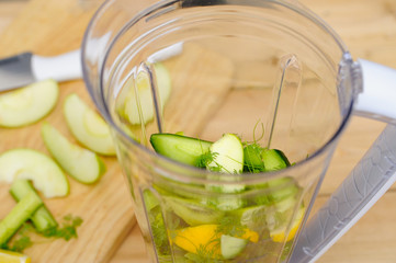 Green colour fruit and vegetables in a blender.