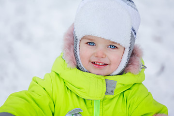 Portrait Happy Little boy in winter clothes in the snow.The boy on the nature