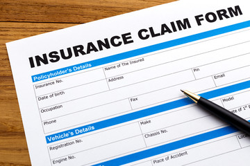 Insurance claim form with pen