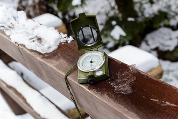 Compass instrument on wooden railing