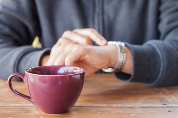 Woman checks the time on a wrist watch