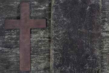 Cross and old leather  on old wooden board