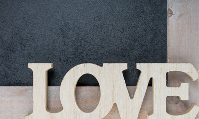 Love / Wooden blackboard with wooden letters and the word Love