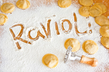 Lettering ravioli on flour with ravioli maker