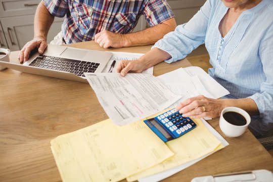 Senior couple checking their bills