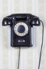 Retro phone on a wooden wall