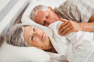 Senior woman awake on bed