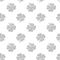 Seamless pattern of abstract four-leaf clovers of silver glitter
