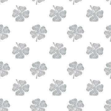 Seamless pattern of abstract four-leaf clovers of silver glitter