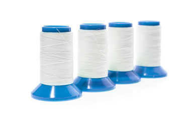 Professional sewing threads on a blue industrial roll.