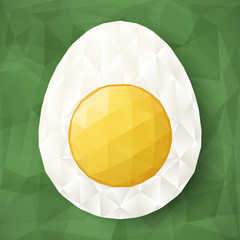 Abstract egg with polygonal surface on green background. Half of boiled egg