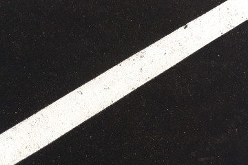 White traffic line on asphalt texture