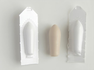 the suppository on the white background; shallow depth of field - obrazy, fototapety, plakaty