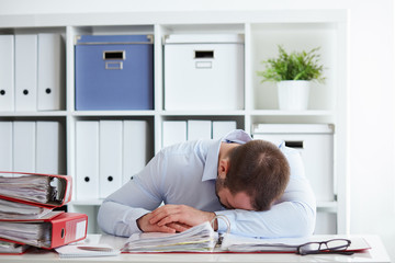 Tired young businessman sleeping