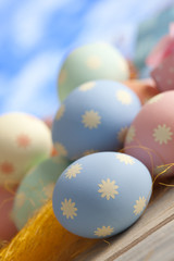 Easter eggs in pastel color on blue sky background