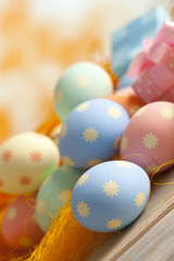 Colored Easter eggs in pastel colors on abstract background