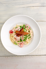 Plate of pasta bacon, cheese, cherry tomatoes