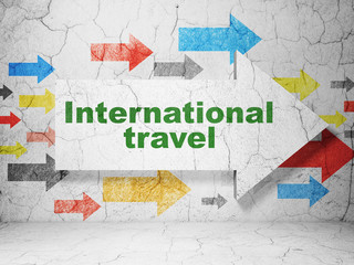 Vacation concept: arrow with International Travel on grunge wall background