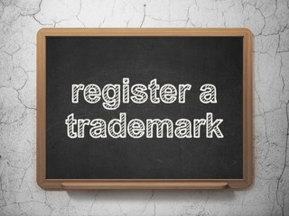 Law concept: Register A Trademark on chalkboard background