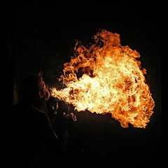 Fire artist performing fire breathing
