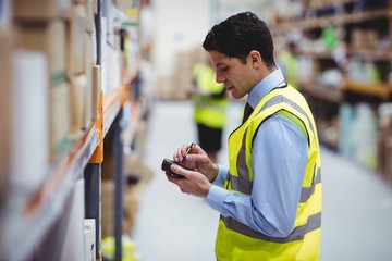 Warehouse worker using hand scanner