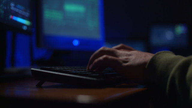 keyboard, a man hacker cracks a password