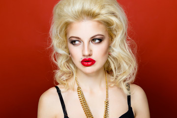 Portrait of beautiful blonde glam rocker woman on orange background. Closeup of Beauty Woman face...