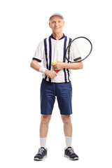 Senior man holding a tennis racket and a ball