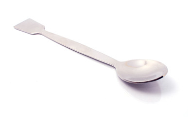 Metal laboratory spoon with spatula isolated on white background