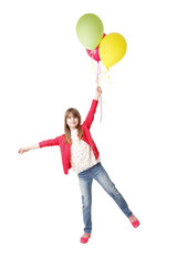 Fototapeta na wymiar Portrait of little girl being carried away by balloons