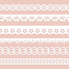 set of white paper laces on the pink background