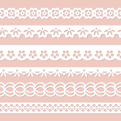 set of white paper laces on the pink background