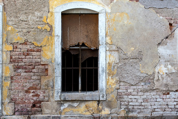 old brick wall with broken window