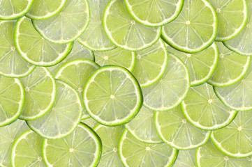 Green background with citrus-fruit of lime slices