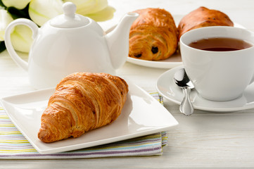 Breakfast with croissants and cup of tea.